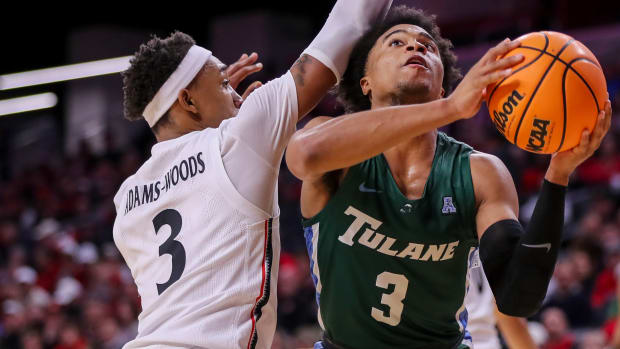 Dec 29, 2022; Cincinnati, Ohio, USA; Tulane Green Wave guard Jalen Cook (3) drives to the basket against Cincinnati Bearcats guard Mika Adams-Woods (3) in the second half at Fifth Third Arena. Mandatory Credit: Katie Stratman-USA TODAY Sports